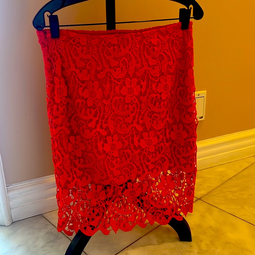 Red lace skirt, size small , zipper on the side.